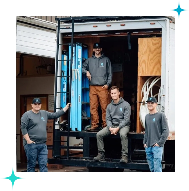 A group of men standing in the back of a truck.