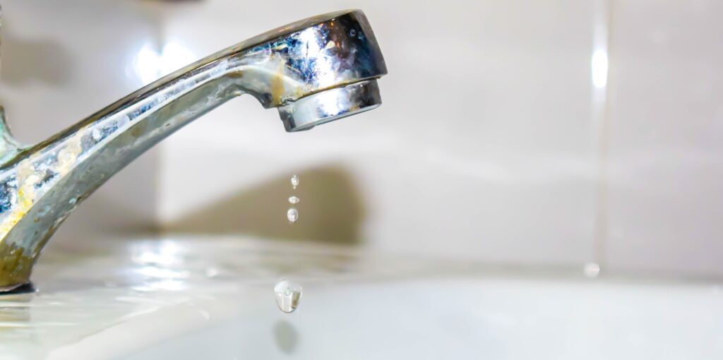 Water leaking from a sink tap