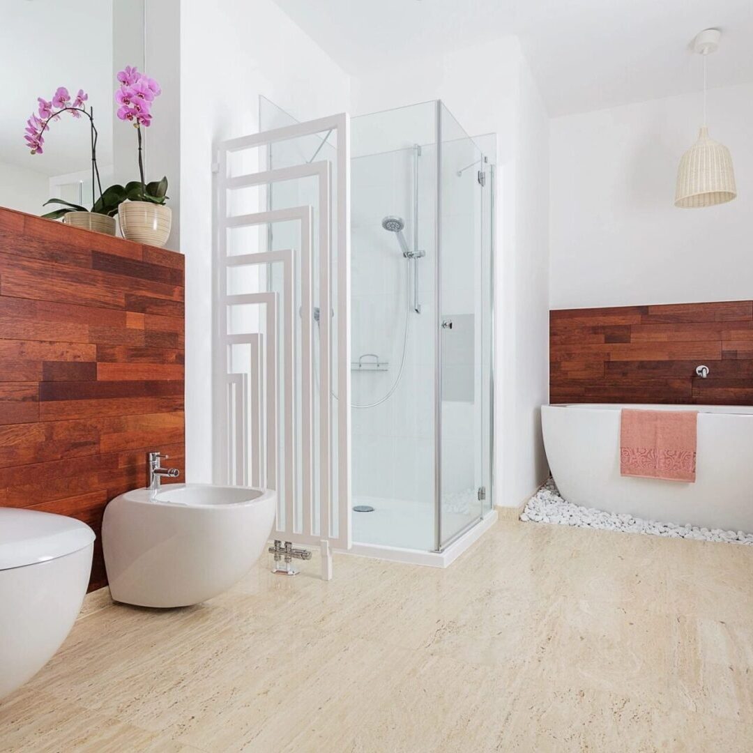 A bathroom with wood floors and white walls.